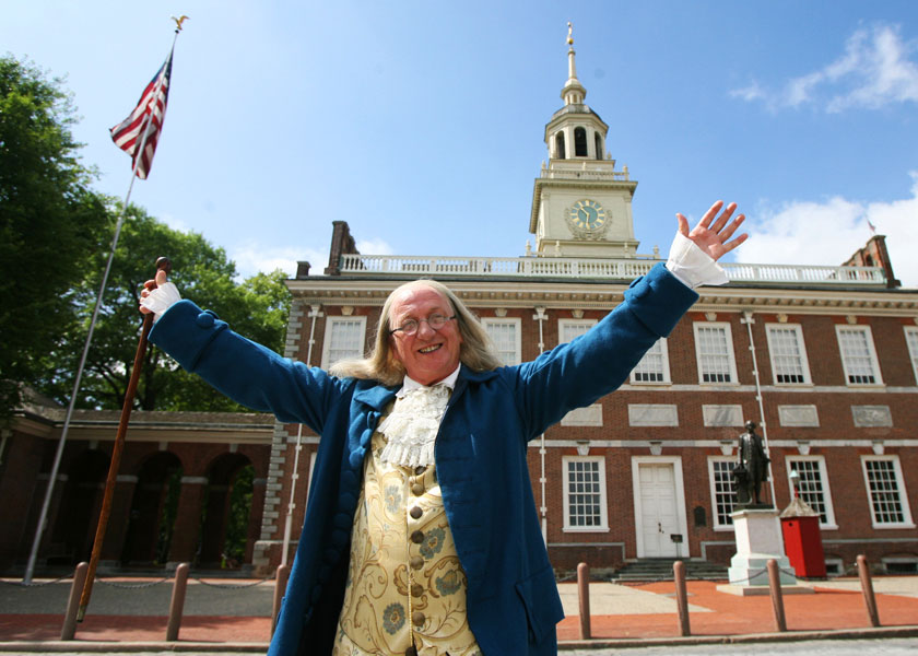 Actor portrays Benjamin Franklin in front of Independence Hall